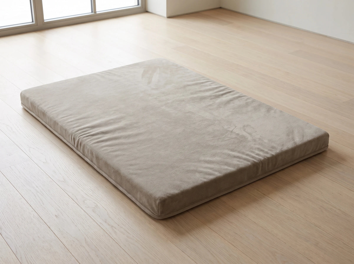The mat lying flat and alone on a wooden floor, its full rectangle in frame